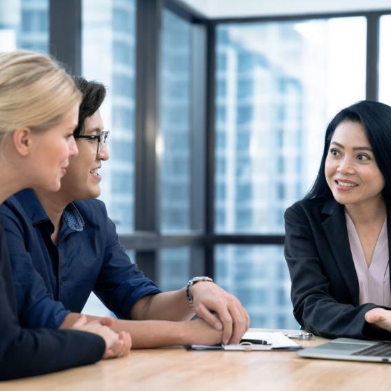 A couple discusses personal loans and credit with a credit union representative