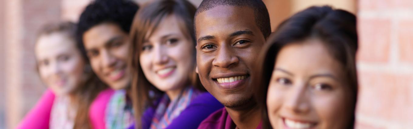 Young looking people's faces in a row