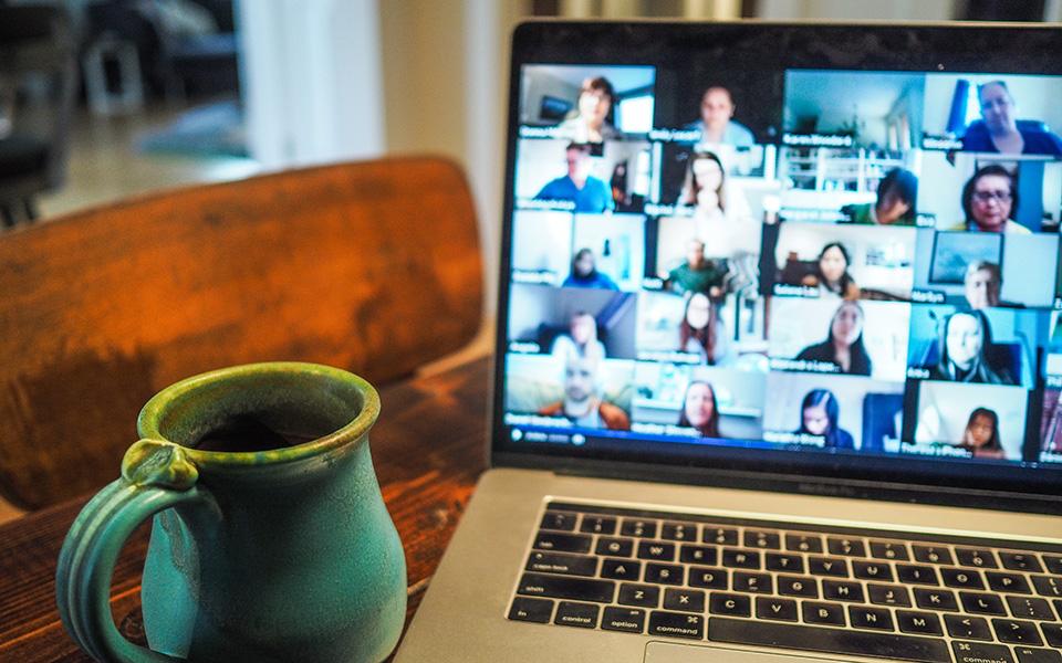 A laptop showing an online meeting