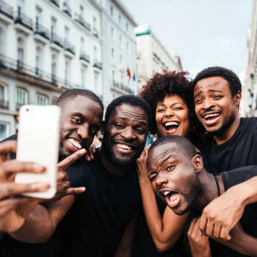 Group of people taking a selfie with smiling faces