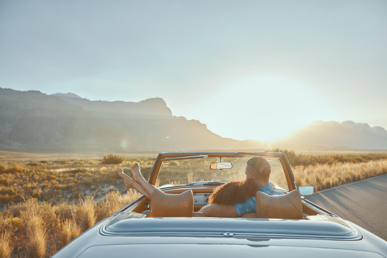 a couple in a car watching the sunset