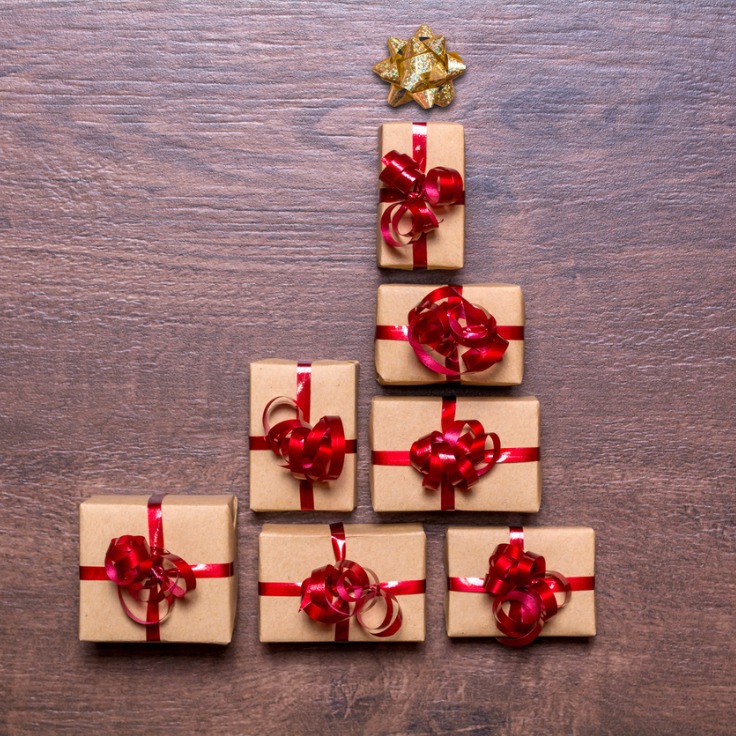 Creative concept with gift boxes christmas tree of gifts on a wooden