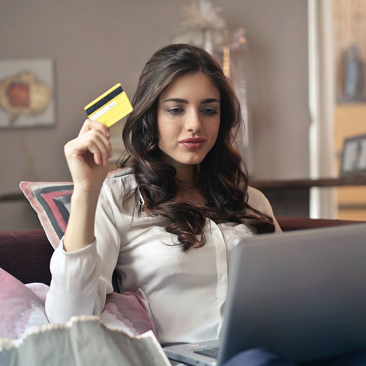 Young woman using credit card