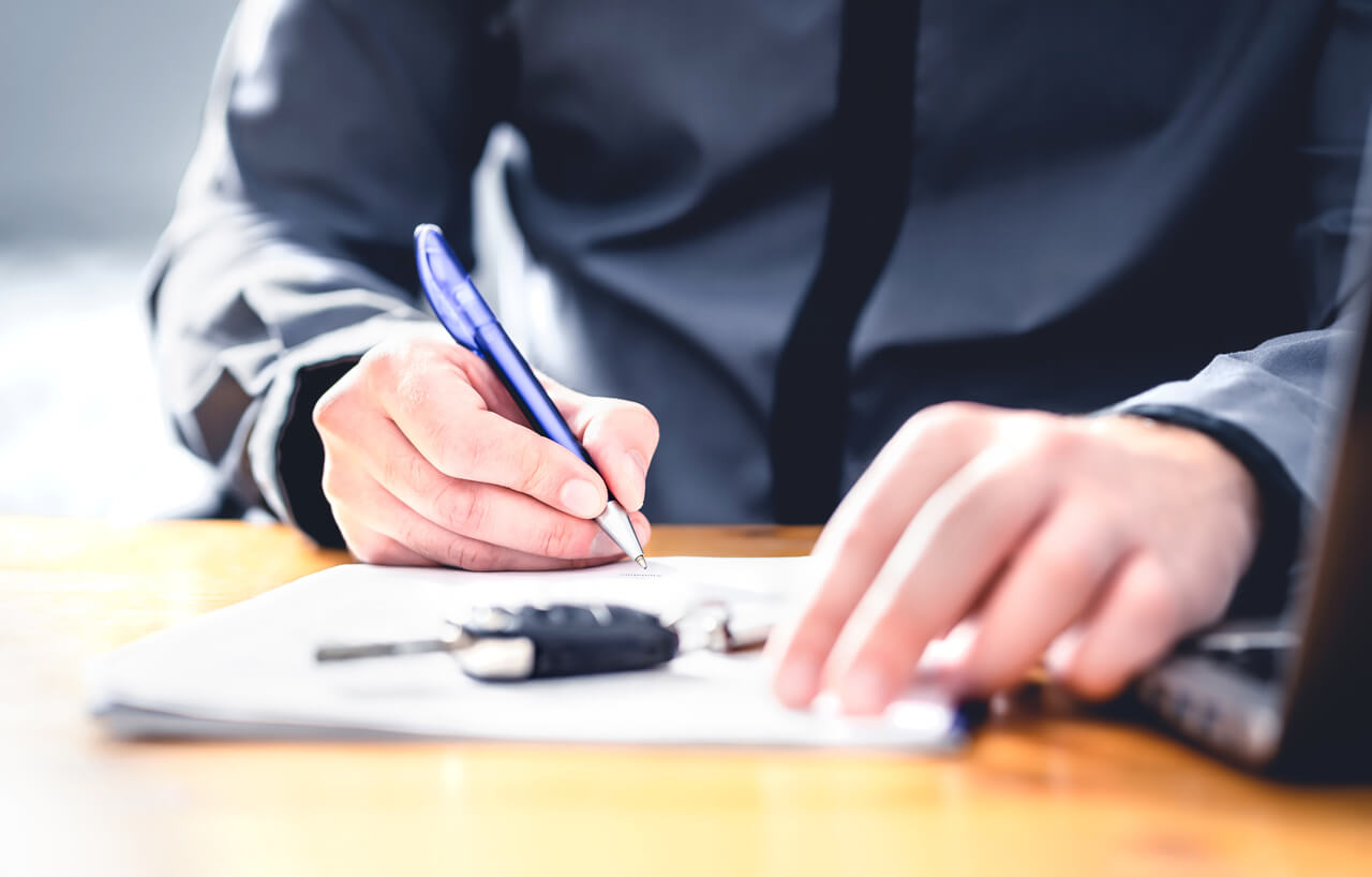 Man signing for auto loan