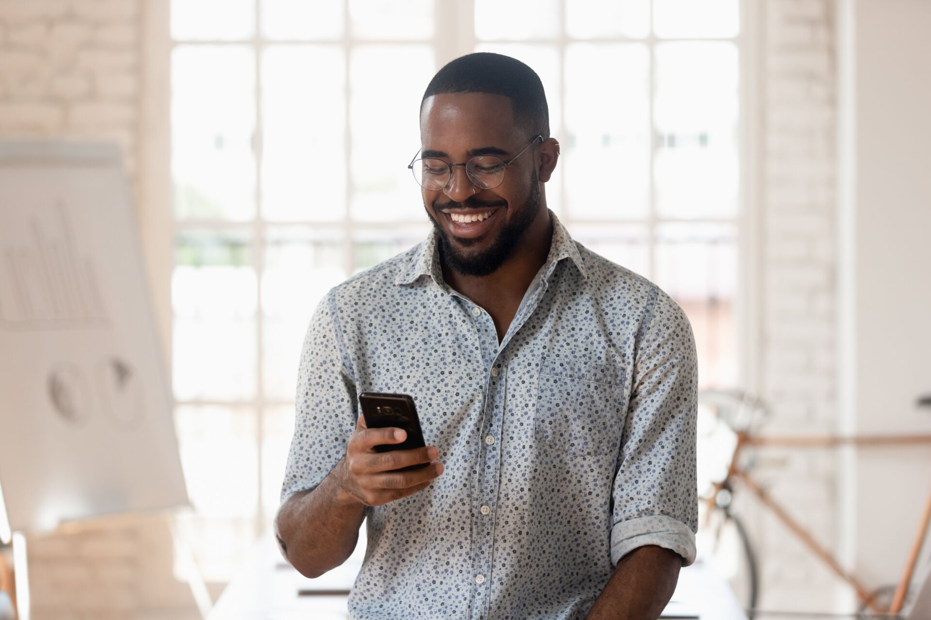 A man checks the growth of his savings in a share certificate using the mobile banking app.