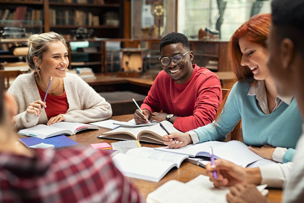 A group of college students study together with school supplies they bought with the money in their standard savings accounts.